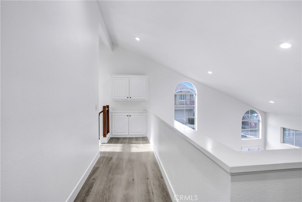 26311 Misty Glen, Unit 3 Lake Forest, CA 92630 - Photo 13 of 27 a view of a hallway with wooden floor and a bathroom
