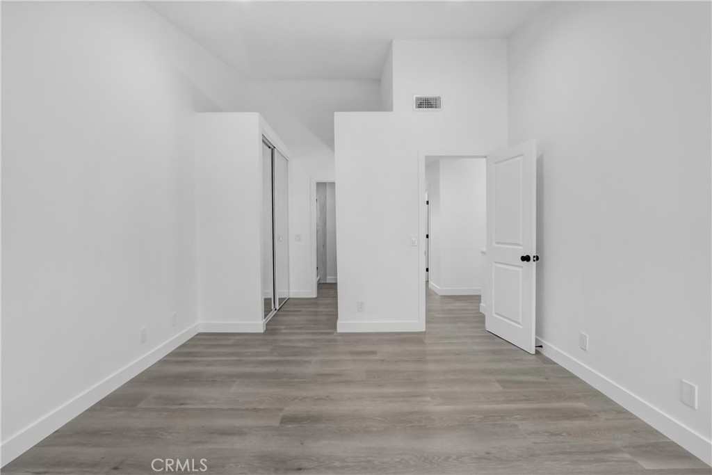 26311 Misty Glen, Unit 3 Lake Forest, CA 92630 - Photo 15 of 27 a view of an empty room with wooden floor