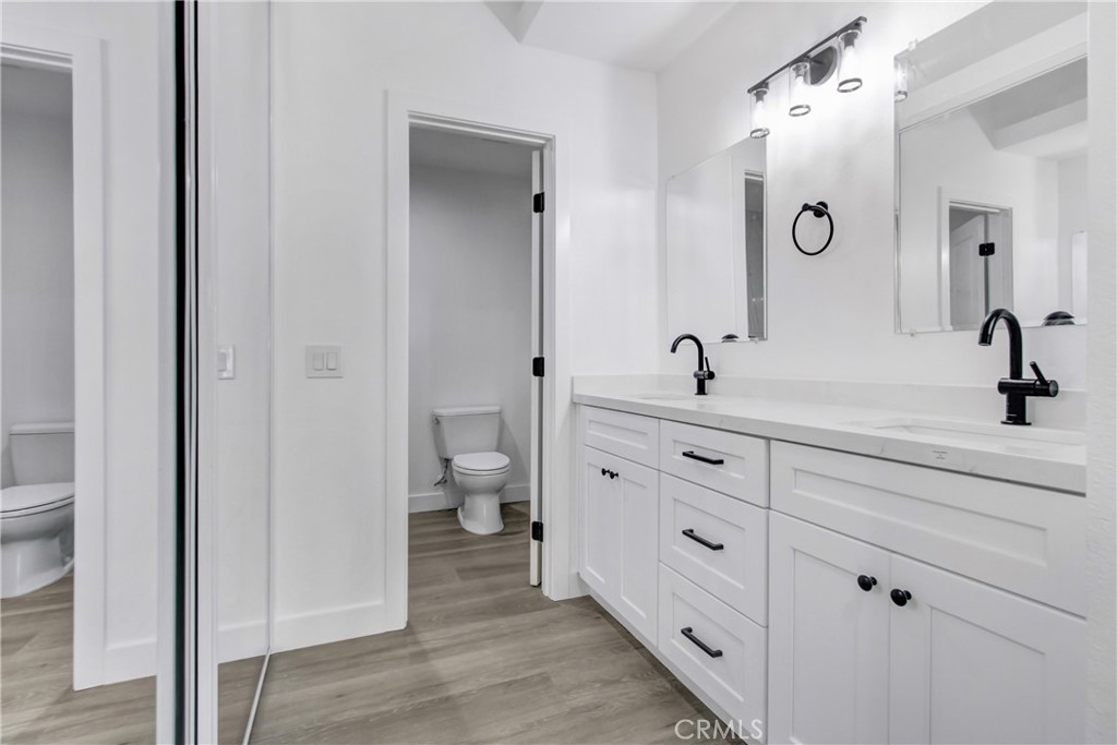26311 Misty Glen, Unit 3 Lake Forest, CA 92630 - Photo 16 of 27 a bathroom with a double vanity sink and mirror with shower