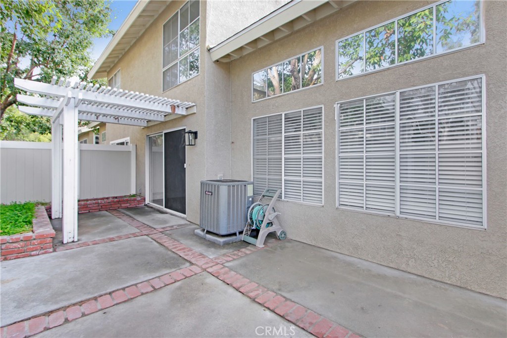 26311 Misty Glen, Unit 3 Lake Forest, CA 92630 - Photo 24 of 27 a view of a house with a patio and a yard