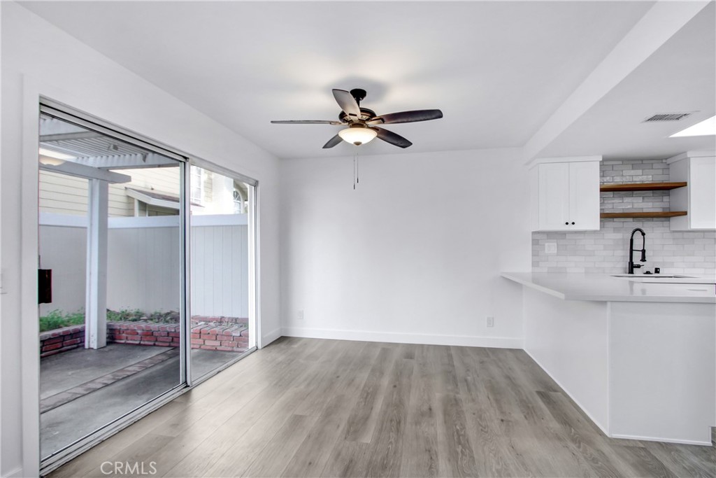 26311 Misty Glen, Unit 3 Lake Forest, CA 92630 - Photo 7 of 27 a view of a kitchen with a sink a ceiling fan and a kitchen stove