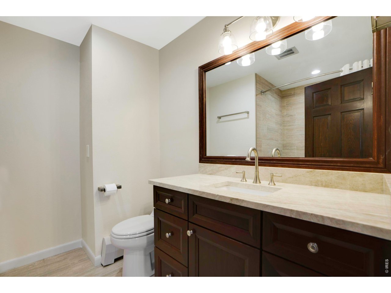 19 Ridge Road Boulder, CO 80303 - Photo 27 of 42 a bathroom with a sink a toilet a large mirror and shower