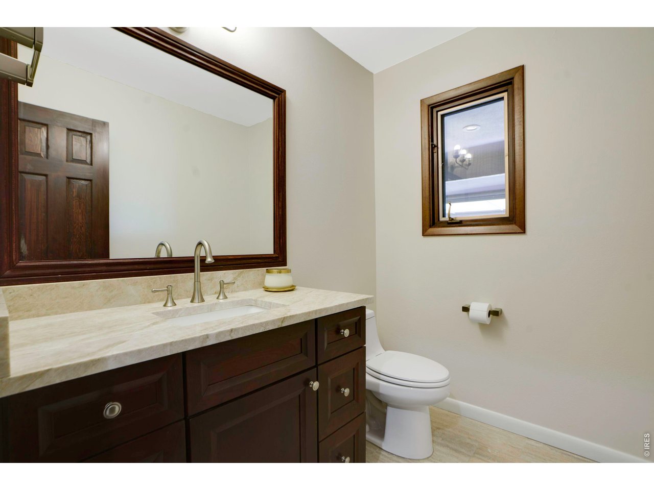 19 Ridge Road Boulder, CO 80303 - Photo 28 of 42 a bathroom with a toilet a sink a mirror a window and vanity
