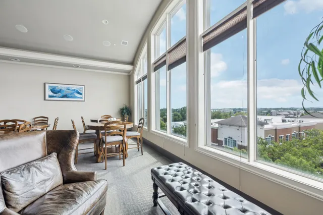 a living room with furniture and a floor to ceiling window