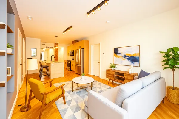 a living room with furniture and a floor to ceiling window