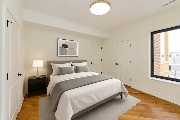 a bedroom with a bed and a window