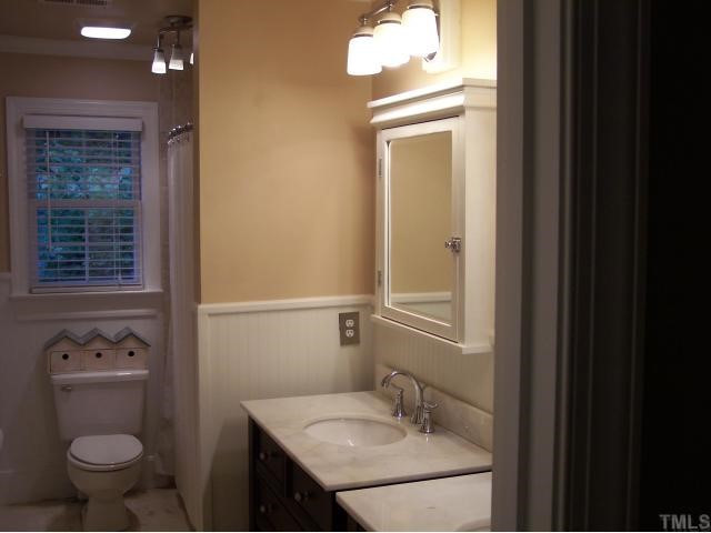 11805 Old Creedmoor Road Raleigh, NC 27613 - Photo 12 of 12 Partial View of the Completely Remodeled Shared Bathroom. Room Features Designer Accent Lighting & Paint, Separate Marble Top Vanities & Medicine Cabinets, Accent Beadboard Walls, Crown Moldings, Travertine Floors and Custom Tile Surround Tub & Shower! Bathroom