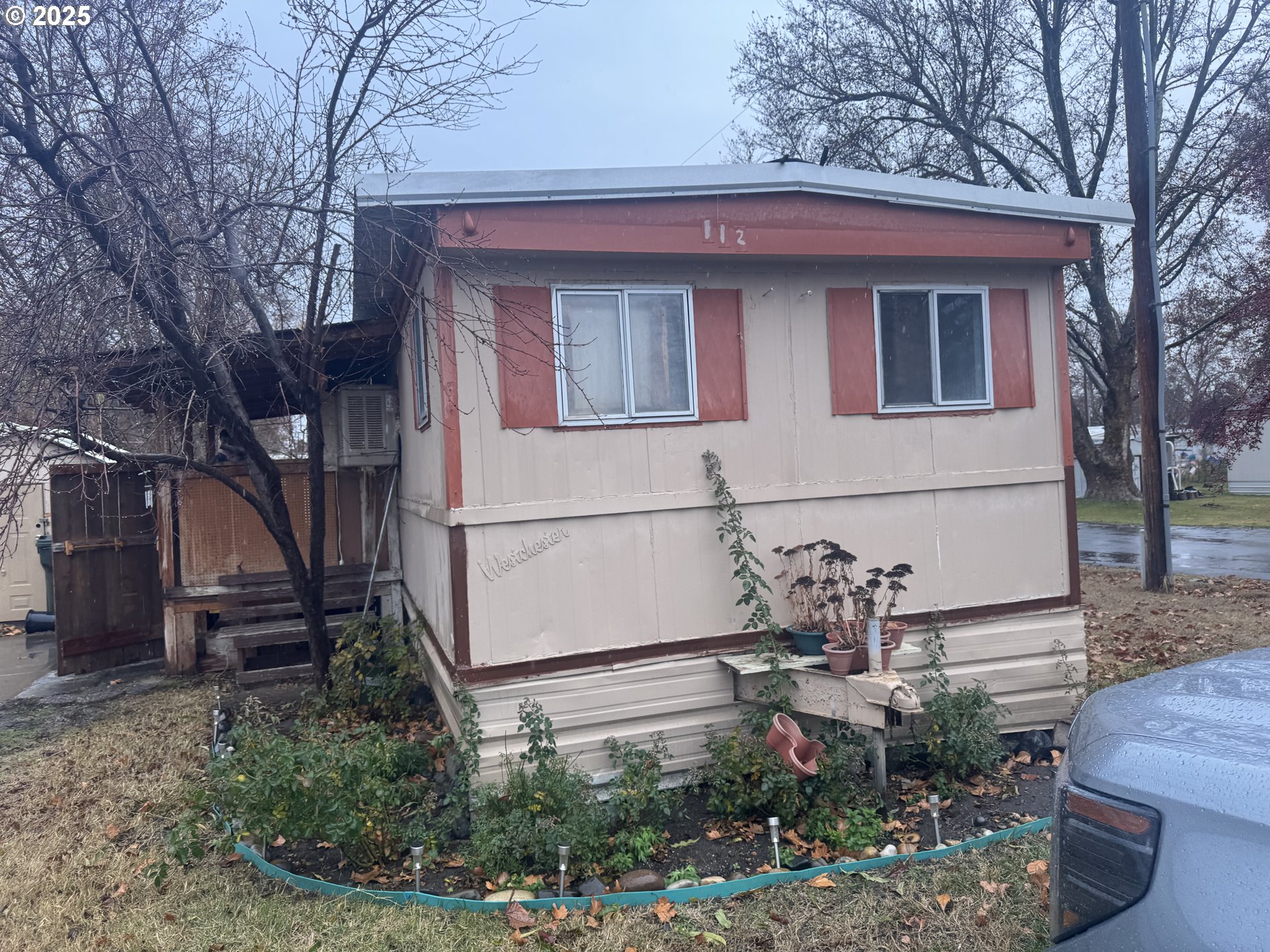 1215 Southwest 11th Street, Unit 112 Hermiston, OR 97838 - Photo 1 of 14 a front view of a house with garden