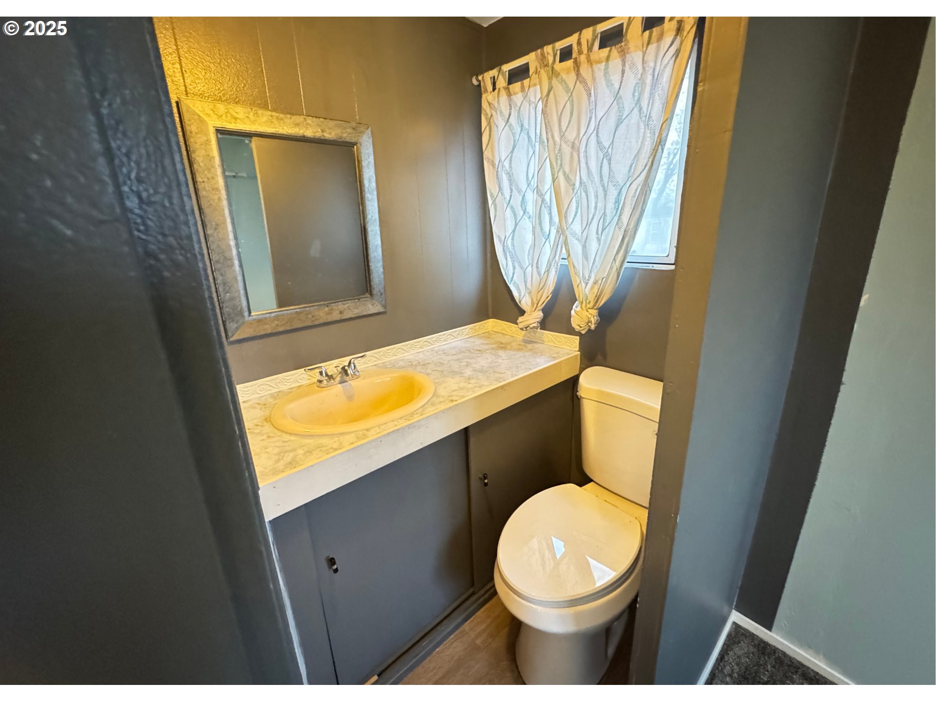 1215 Southwest 11th Street, Unit 112 Hermiston, OR 97838 - Photo 7 of 14 a bathroom with a granite countertop toilet sink and mirror