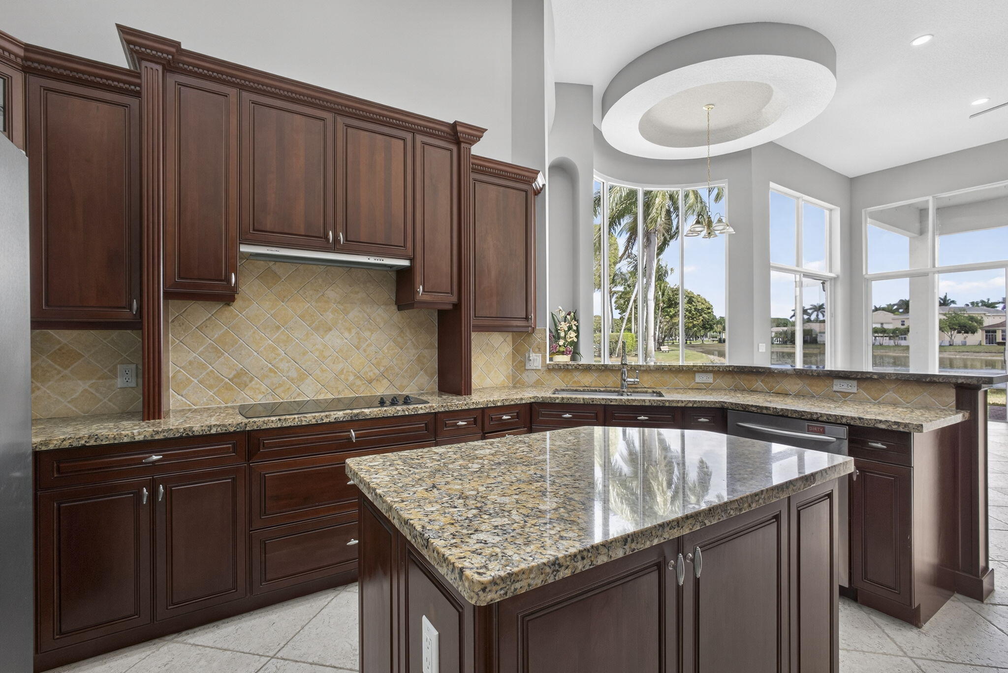 2162 Stotesbury Way Wellington, FL 33414 - Photo 11 of 41 a kitchen with granite countertop a sink and a wooden cabinets