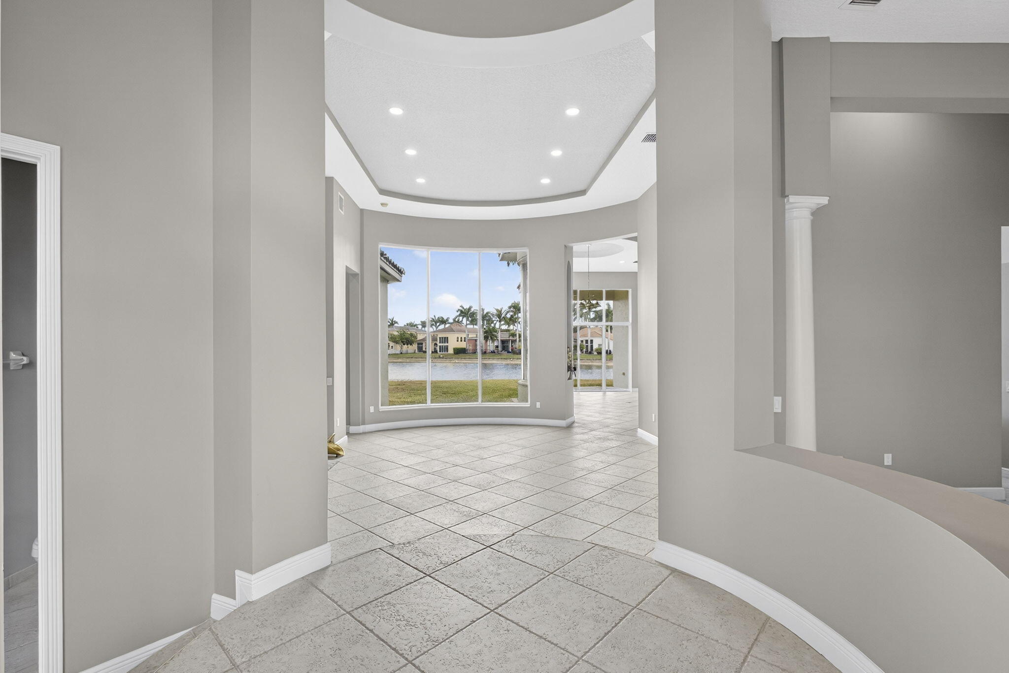 2162 Stotesbury Way Wellington, FL 33414 - Photo 2 of 41 a view of a hallway with wooden floor and a living room