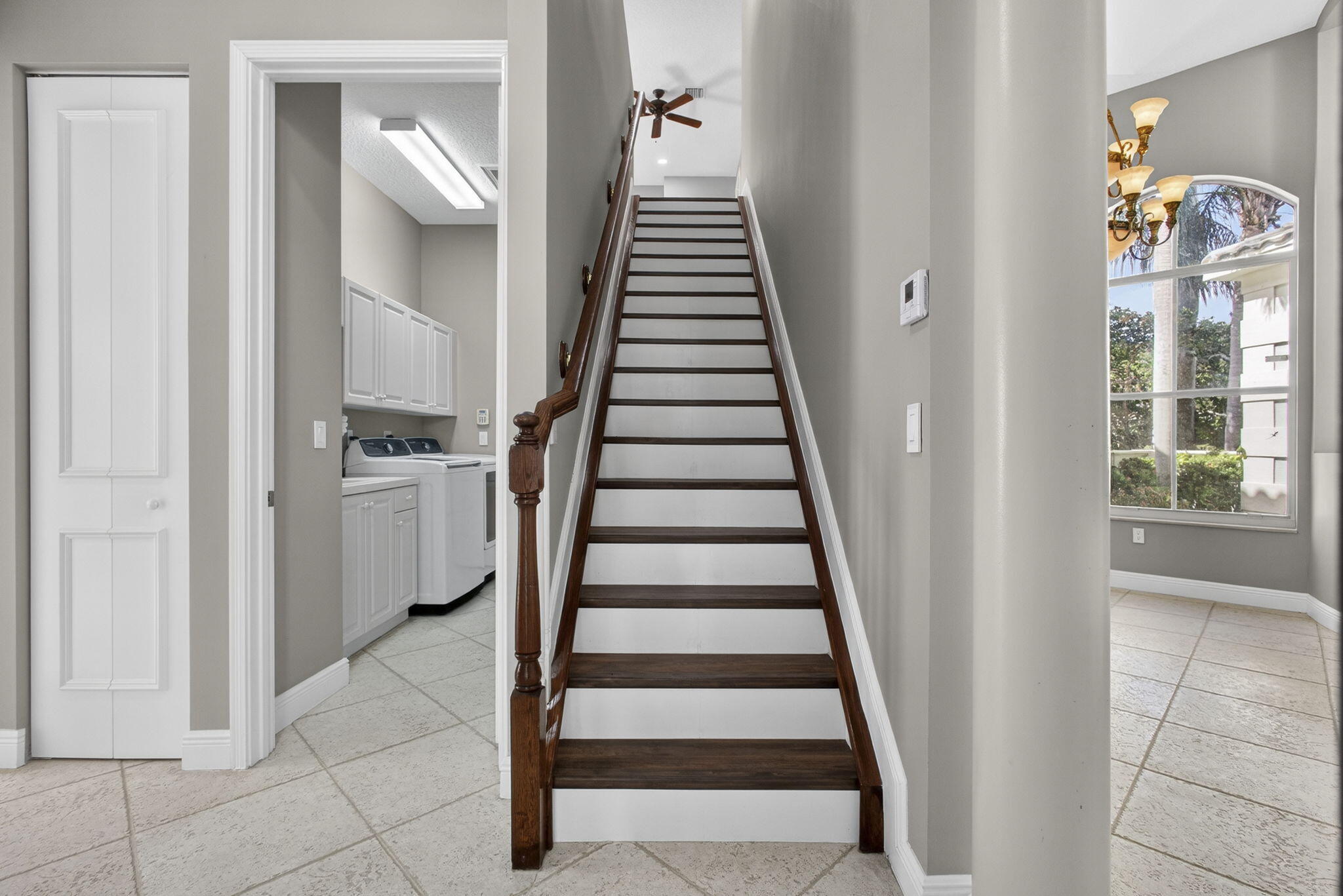 2162 Stotesbury Way Wellington, FL 33414 - Photo 27 of 41 a view of a hallway with front door wooden floor and stairs