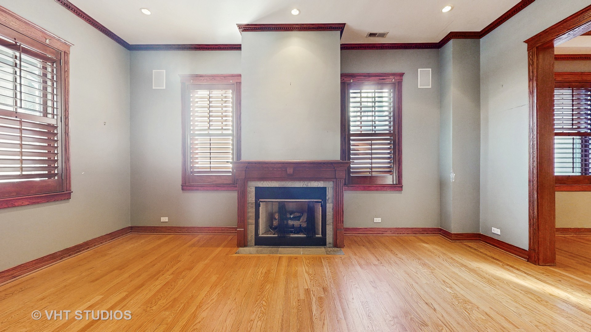 3814 North Janssen Avenue Chicago, IL 60613 - Photo 13 of 56 a view of an empty room with wooden floor and a window