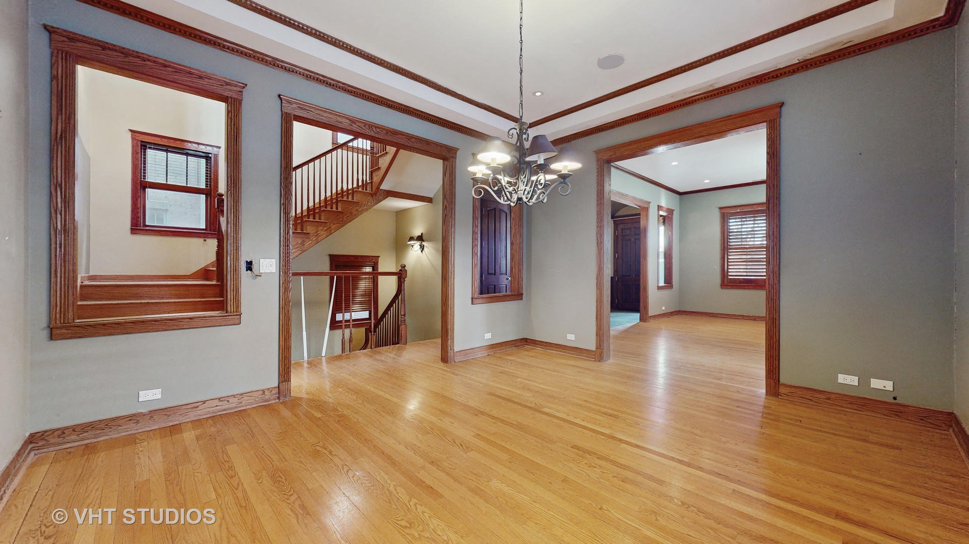 3814 North Janssen Avenue Chicago, IL 60613 - Photo 17 of 56 a view of empty room with a fireplace chandelier and wooden floor