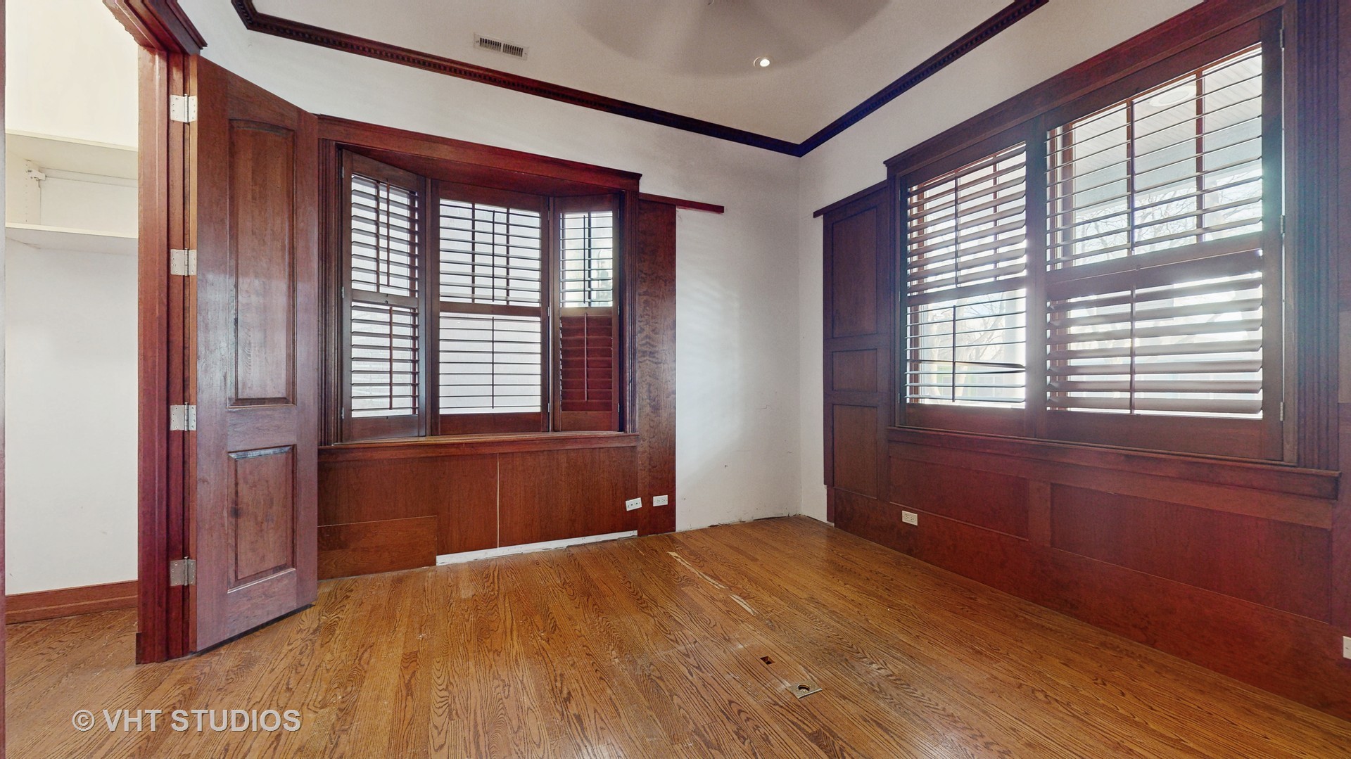 3814 North Janssen Avenue Chicago, IL 60613 - Photo 19 of 56 a view of empty room with wooden floor and fan