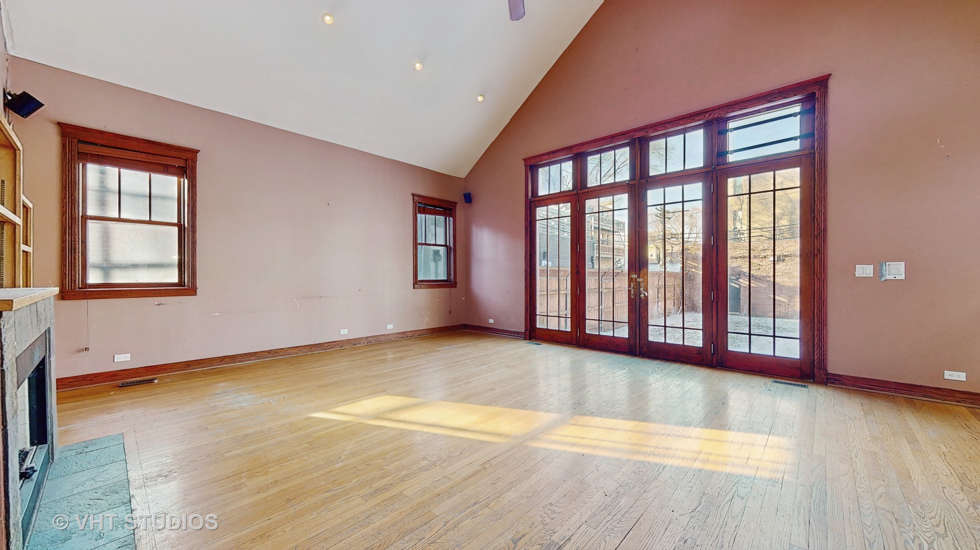 3814 North Janssen Avenue Chicago, IL 60613 - Photo 5 of 56 a view of an empty room with wooden floor and a window