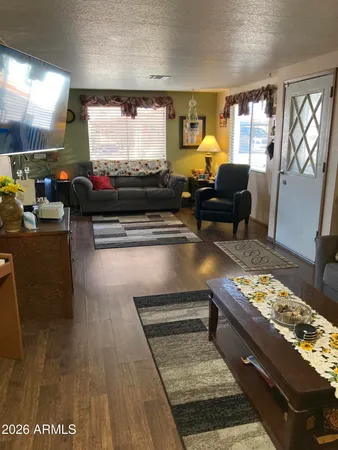 a living room with furniture and a open kitchen