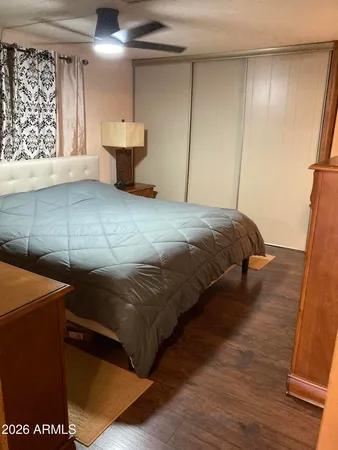 a bedroom with a bed and a mirror