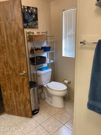 a white toilet sitting next to a bathroom sink
