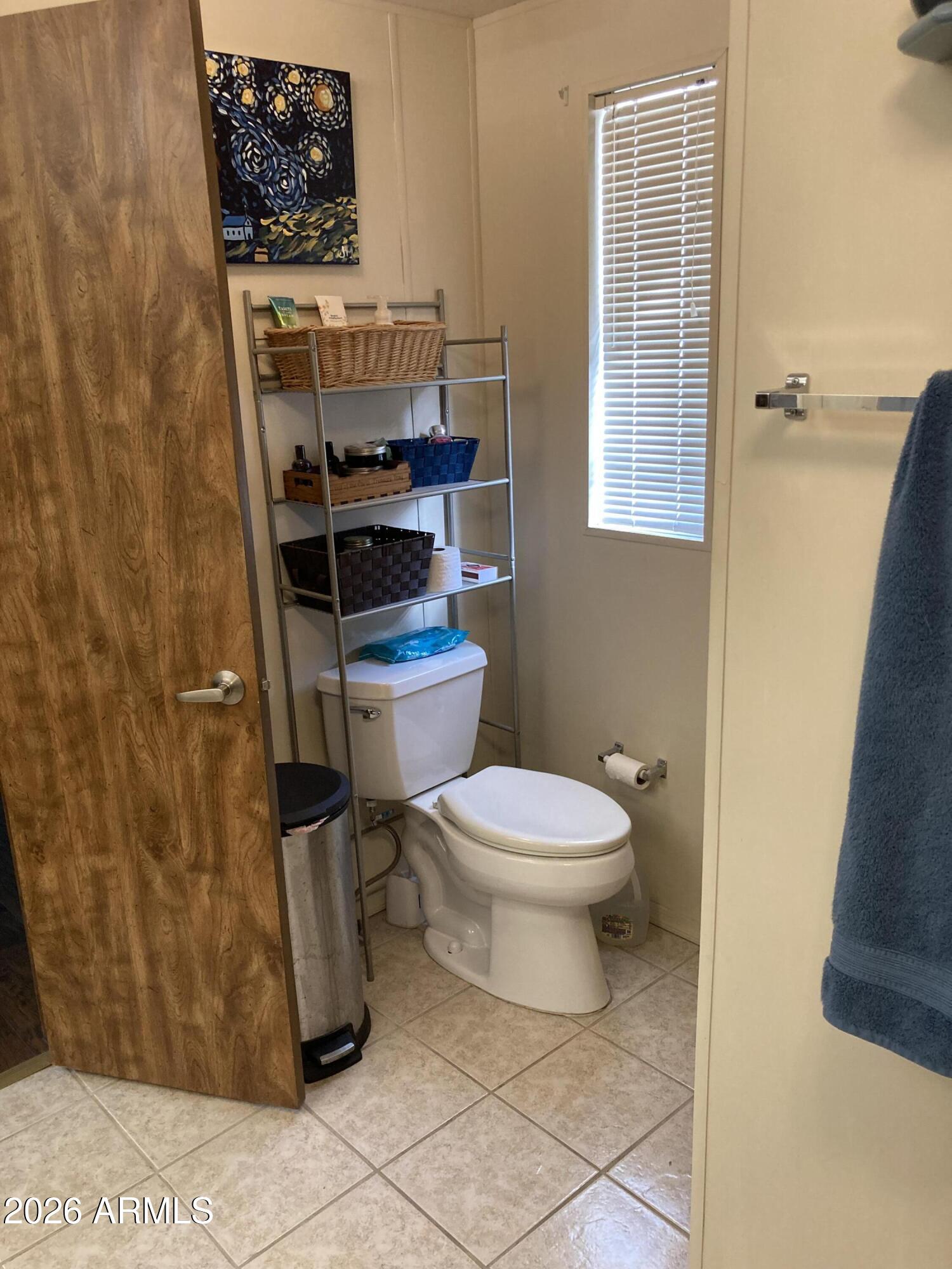 3104 East Broadway Road, Unit 203 Mesa, AZ 85204 - Photo 14 of 24 a white toilet sitting next to a bathroom sink