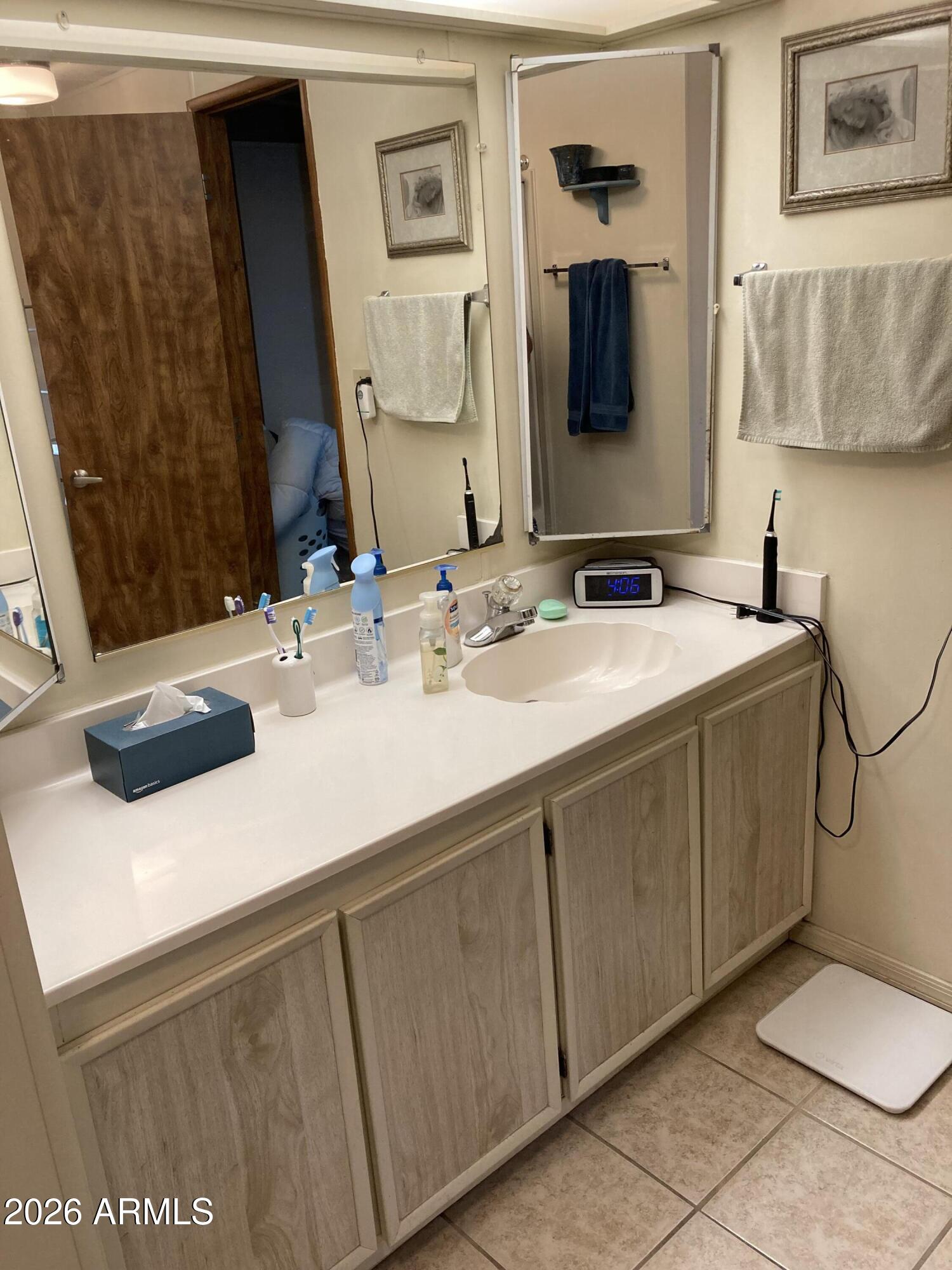 3104 East Broadway Road, Unit 203 Mesa, AZ 85204 - Photo 15 of 24 a bathroom with a sink and a mirror