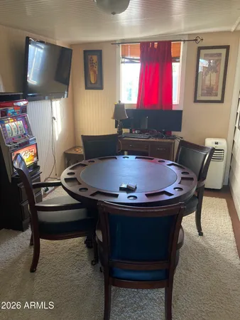 a room with furniture pool table and a flat screen tv