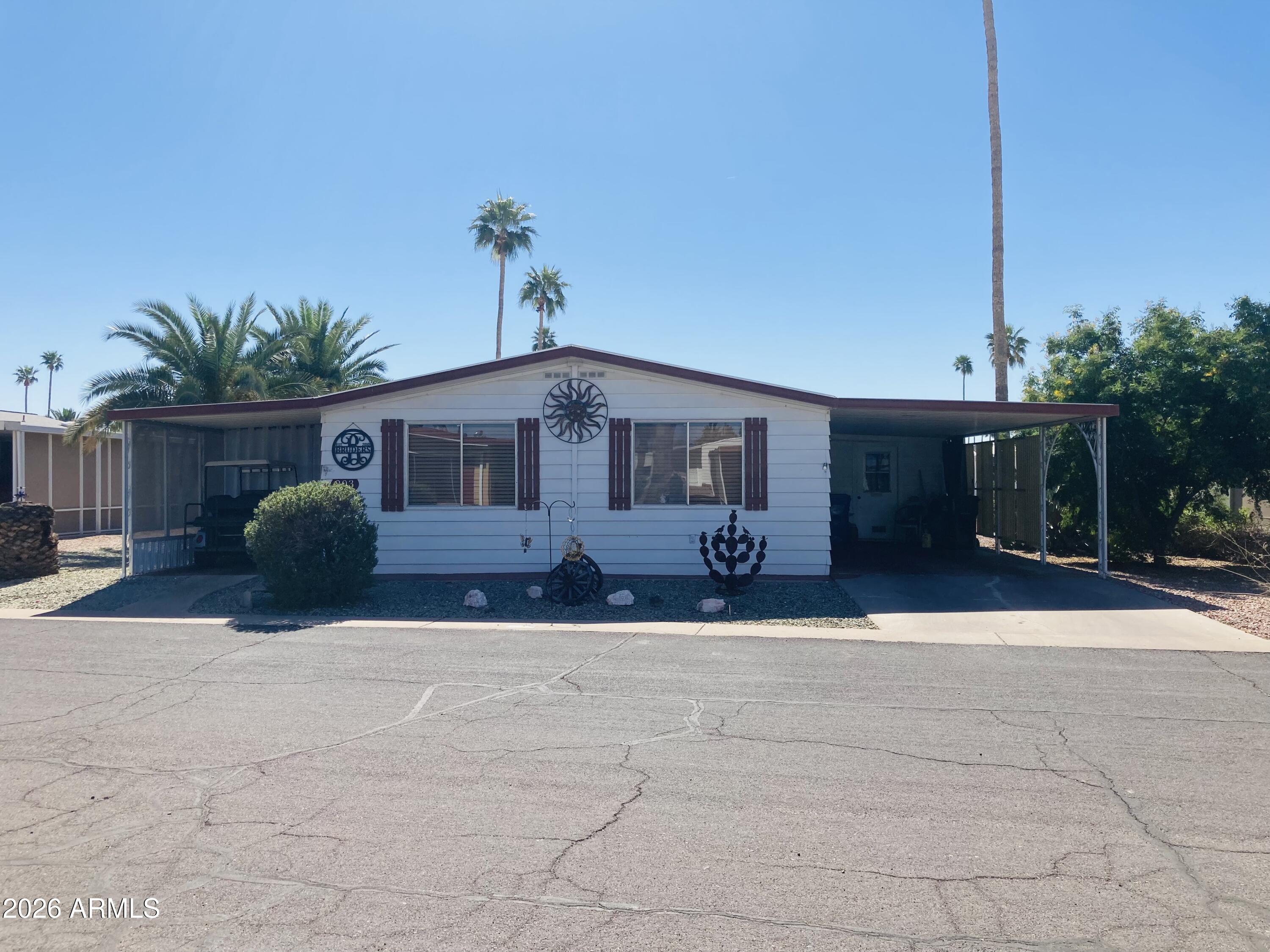 3104 East Broadway Road, Unit 203 Mesa, AZ 85204 - Photo 2 of 24 a front view of a house with a yard and garage
