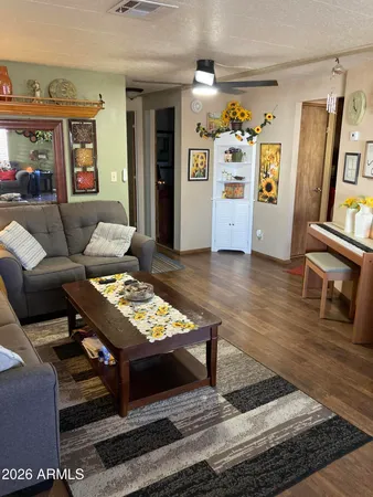 a living room with furniture and a wooden floor