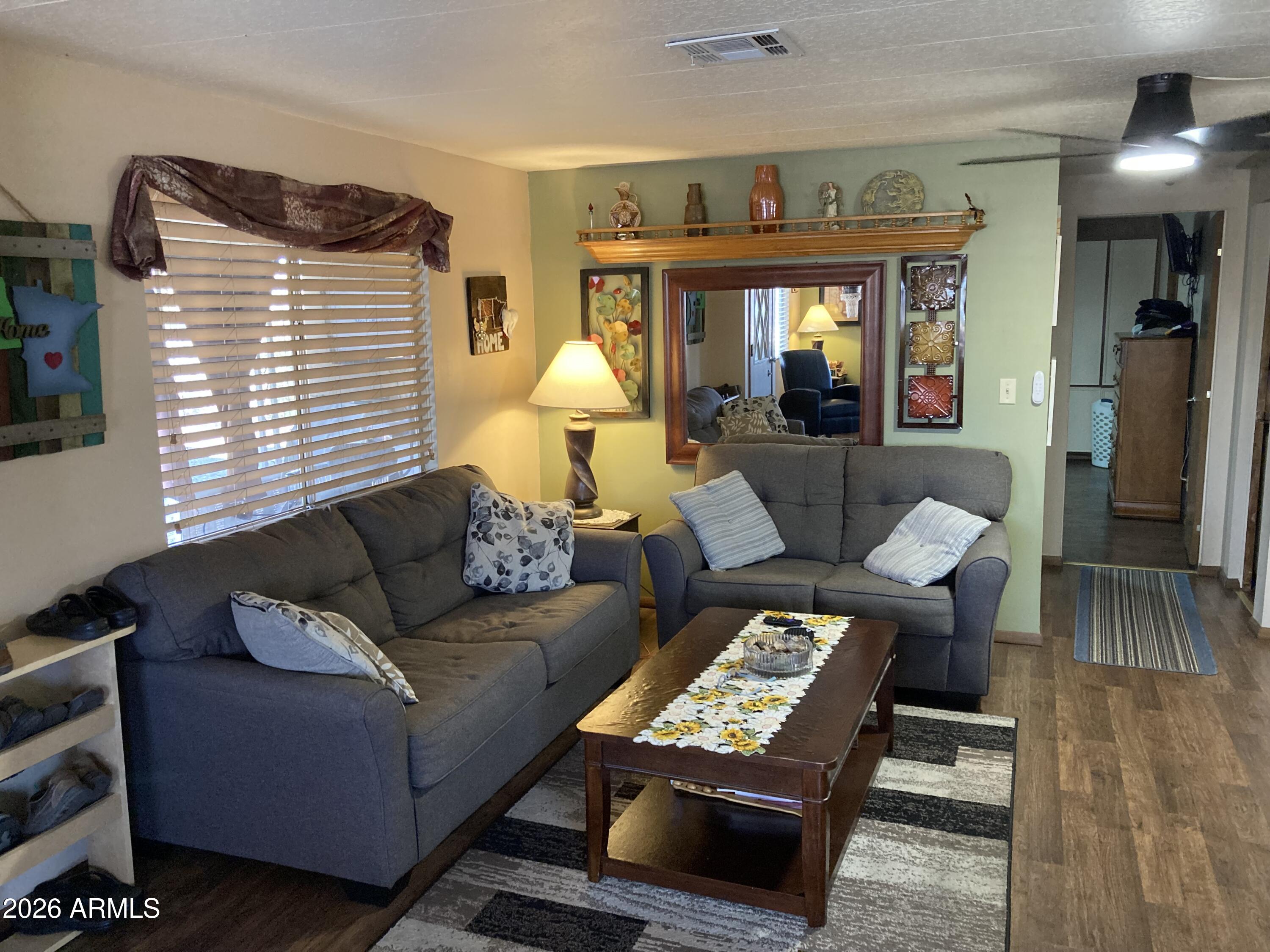 3104 East Broadway Road, Unit 203 Mesa, AZ 85204 - Photo 3 of 24 a living room with furniture and wooden floor