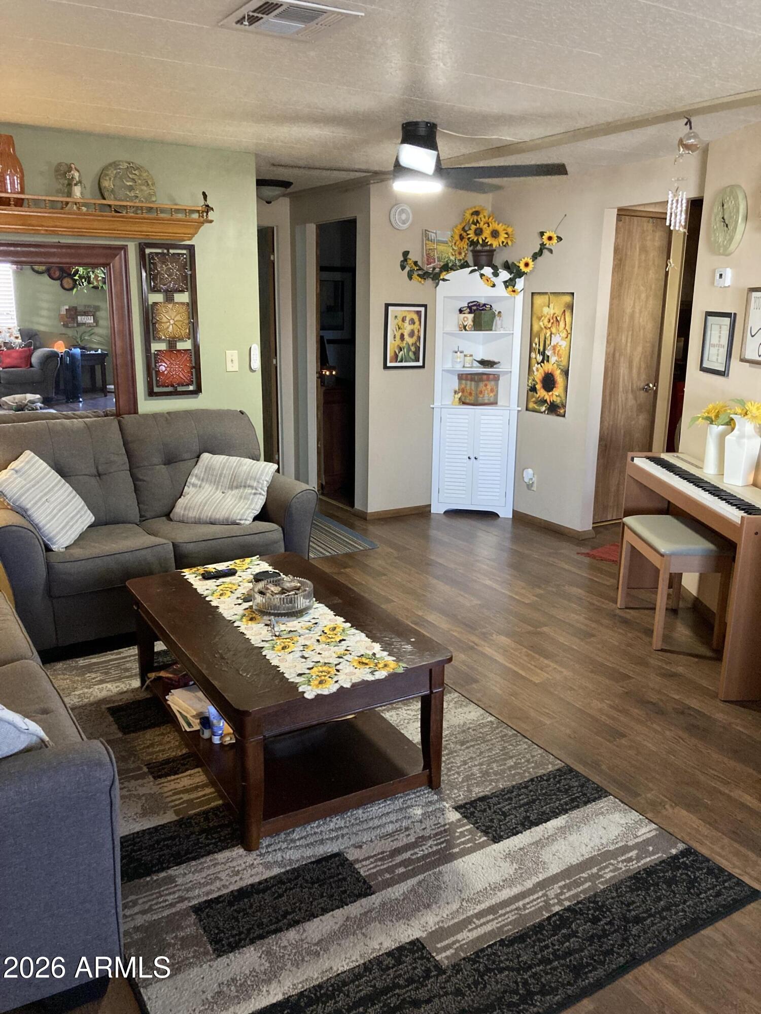 3104 East Broadway Road, Unit 203 Mesa, AZ 85204 - Photo 4 of 24 a living room with furniture and a wooden floor