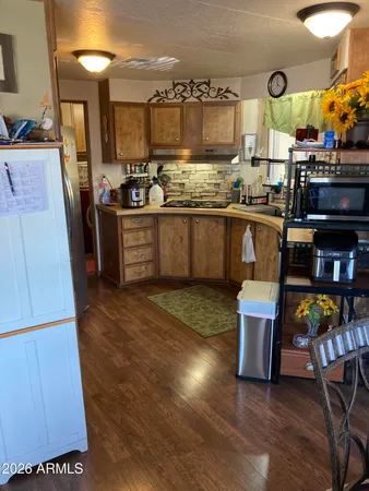 a kitchen with stainless steel appliances granite countertop a sink and a stove