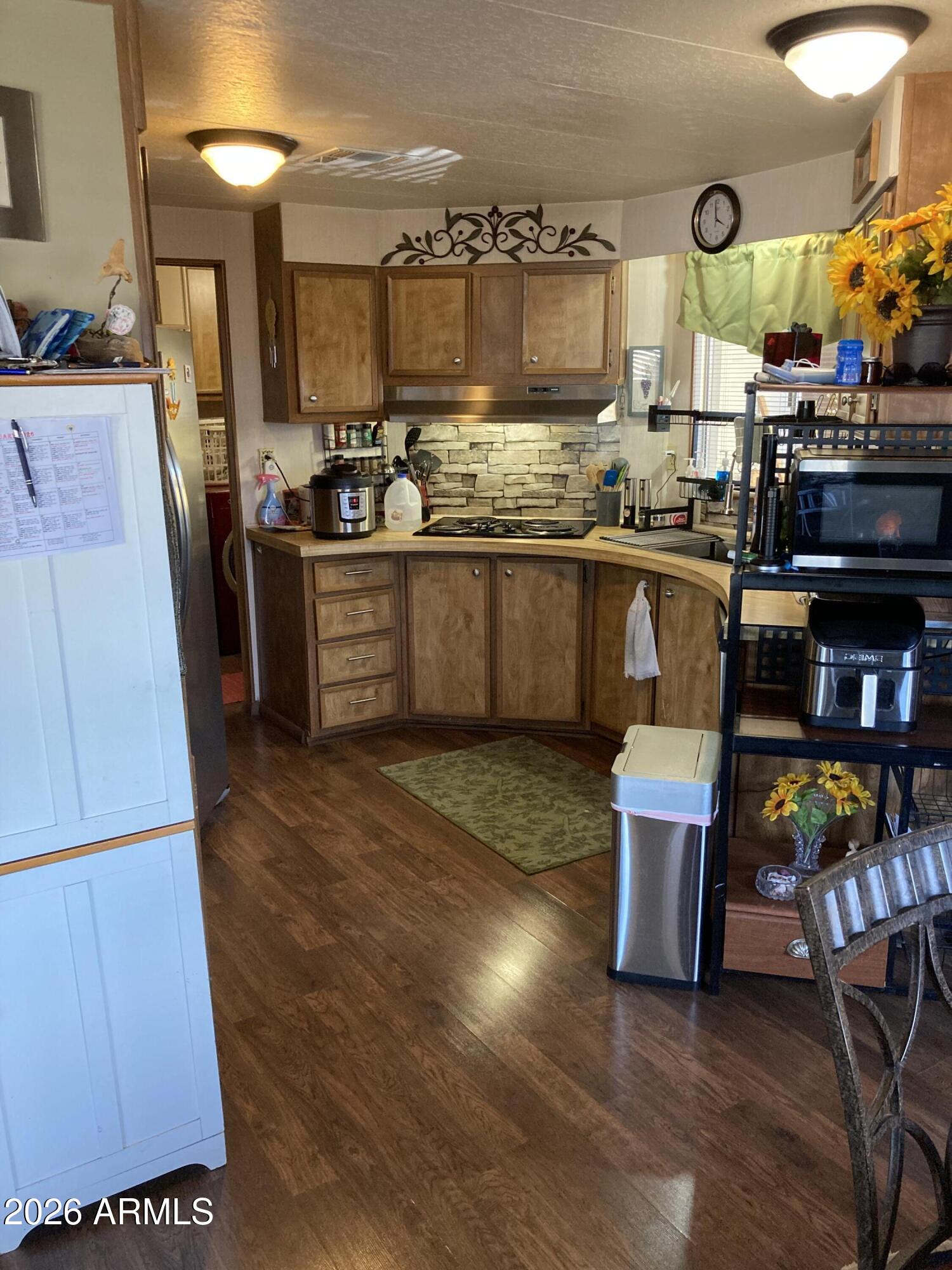 3104 East Broadway Road, Unit 203 Mesa, AZ 85204 - Photo 7 of 24 a kitchen with stainless steel appliances granite countertop a sink and a stove