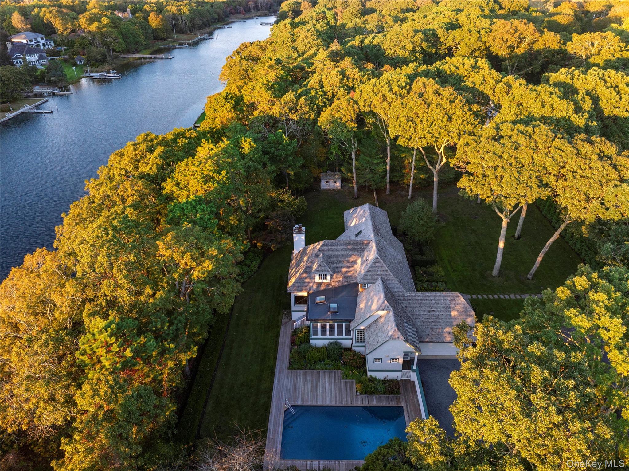 8 Fish Creek Lane Remsenburg, NY 11960 - Photo 5 of 34 an aerial view of a house with swimming pool and lake view