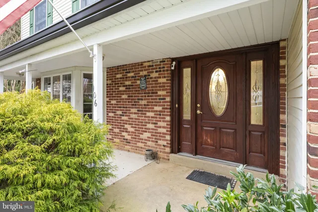 a view of a hallway view with wooden floor and staircase