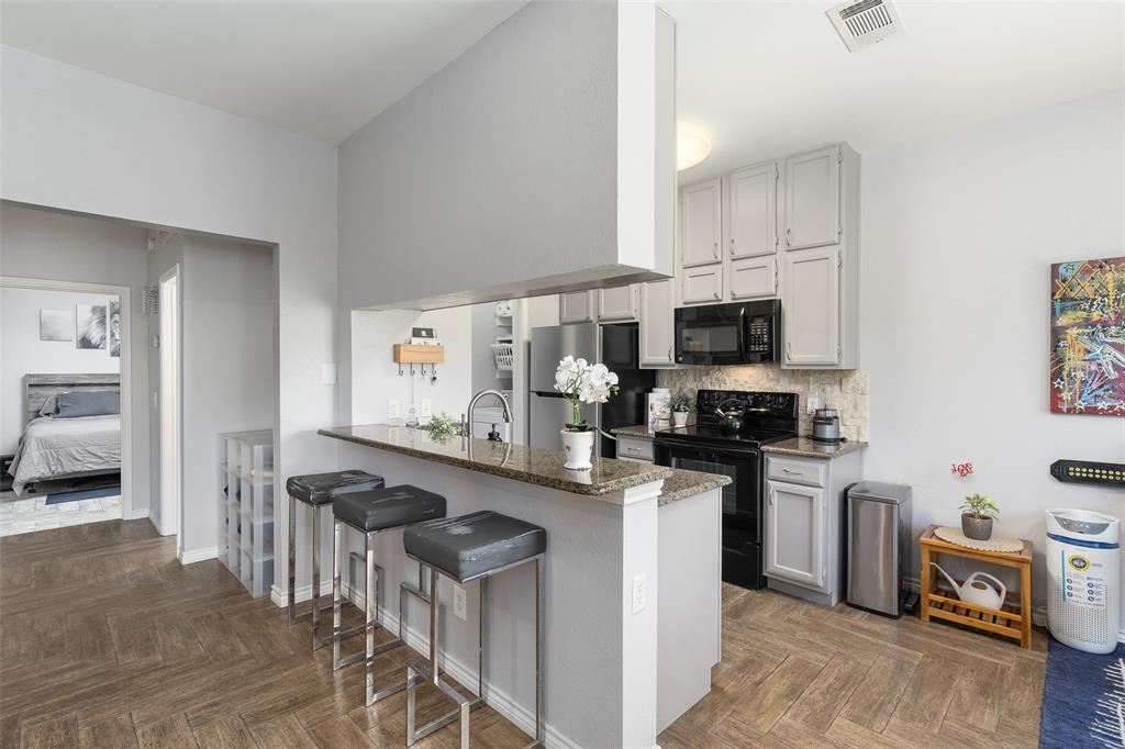 7340 Skillman Street, Unit 1113 Dallas, TX 75231 - Photo 13 of 31 Granite C-Tops & Breakfast Bar Updated SS Appliances & White Cabinetry!