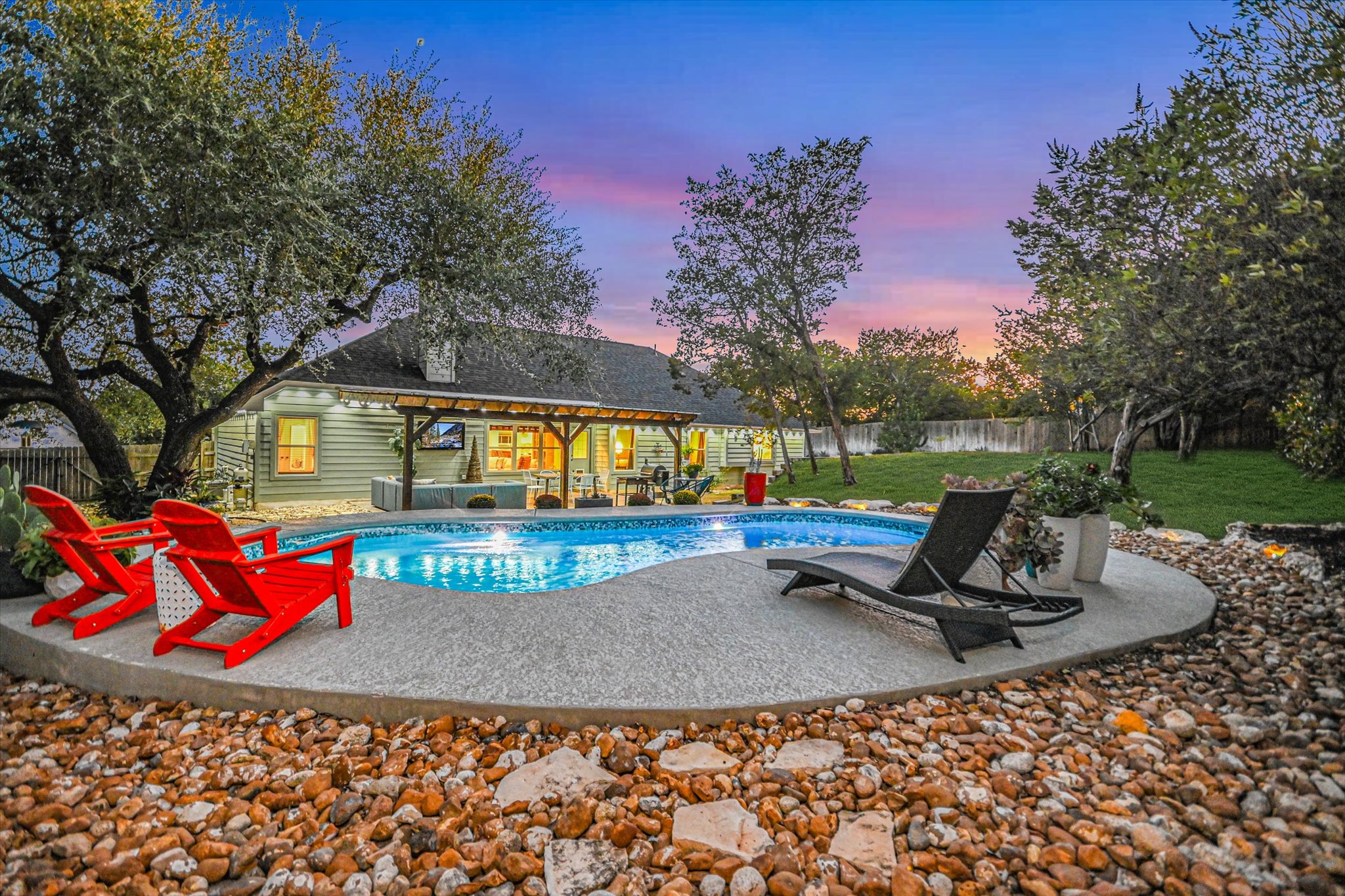 36 Ridgewood Circle Wimberley, TX 78676 - Photo 3 of 30 Mature trees frame a private backyard oasis complete with a sparkling in-ground pool.