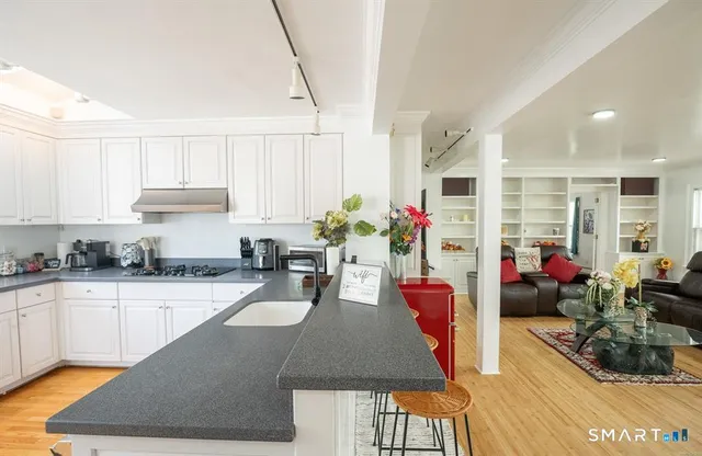 a kitchen with sink and cabinets