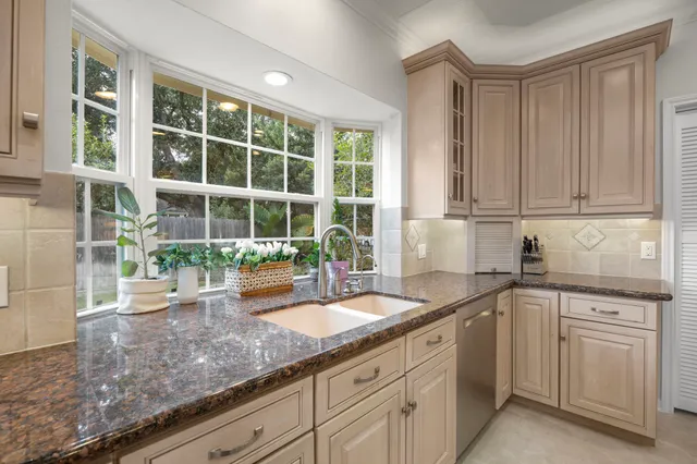 a kitchen that has a sink and a stove