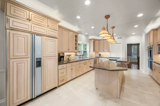 a kitchen with cabinets and window