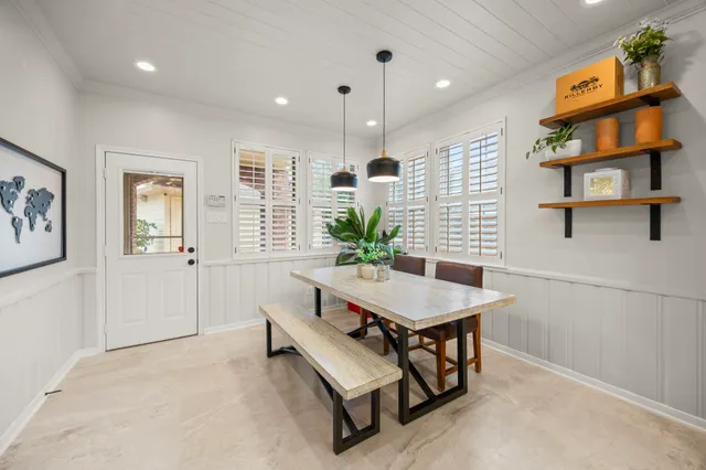 a large kitchen with kitchen island white cabinets and stainless steel appliances