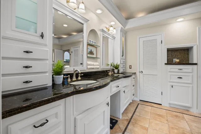 a bedroom with a large bed and ceiling fan