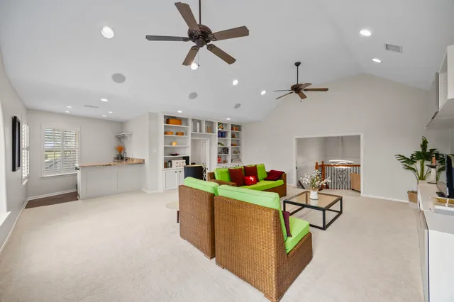 a living room with furniture and a potted plant
