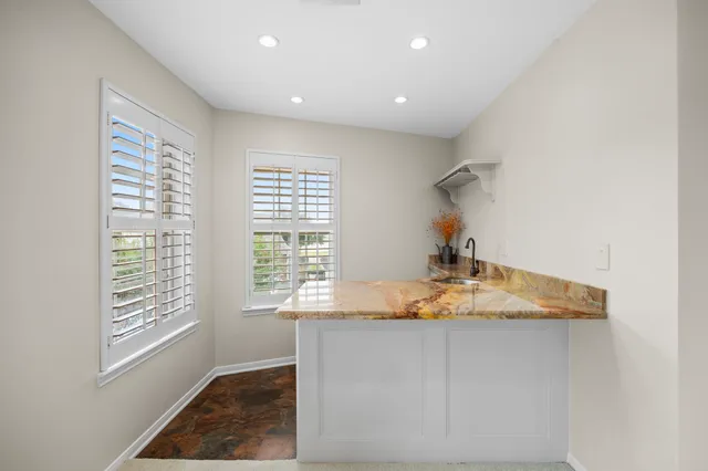 a living room with furniture and kitchen view