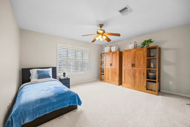 a bedroom with bed and a large window