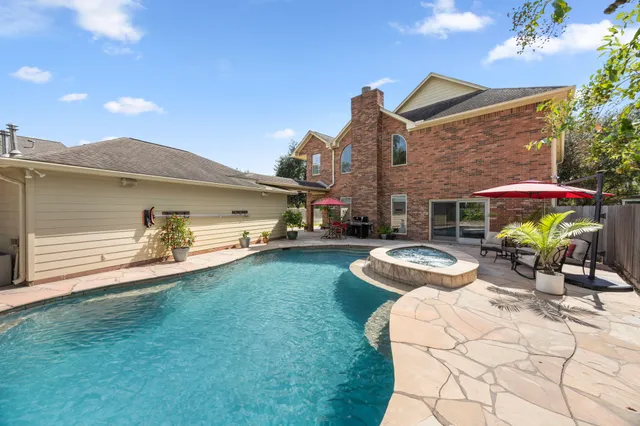 a view of a house with a backyard porch and sitting area