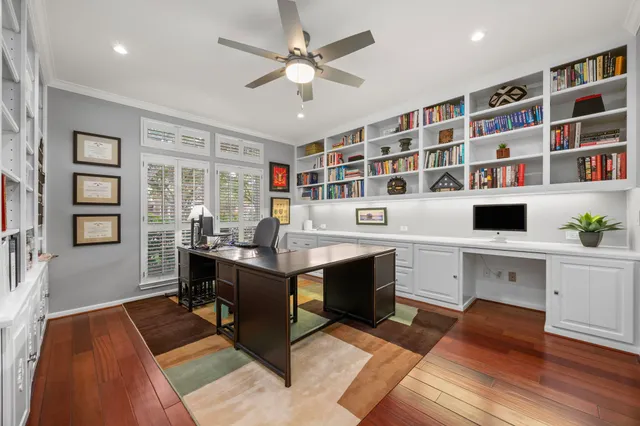 a view of a workspace with furniture and a bookshelf