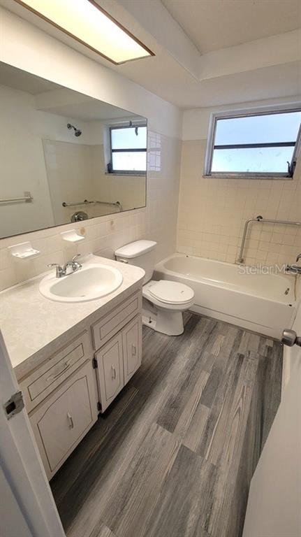 9202 Suffolk Lane Port Richey, FL 34668 - Photo 11 of 20 a bathroom with a sink toilet and mirror