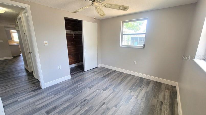 9202 Suffolk Lane Port Richey, FL 34668 - Photo 13 of 20 wooden floor in an empty room with a window