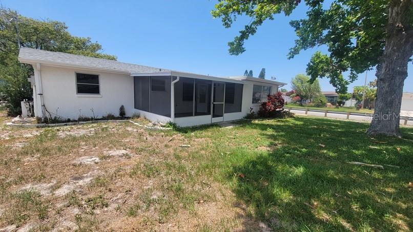 9202 Suffolk Lane Port Richey, FL 34668 - Photo 19 of 20 a view of a house with a yard