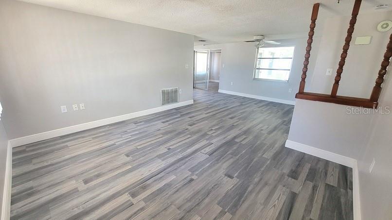 9202 Suffolk Lane Port Richey, FL 34668 - Photo 4 of 20 wooden floor in an empty room with a window